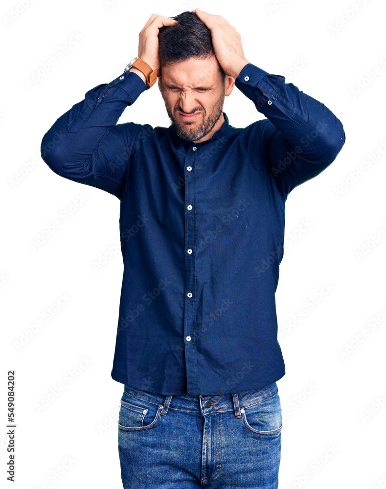Young handsome man wearing casual shirt suffering from headache desperate and stressed because pain and migraine. hands on head. Young handsome man wearing casual shirt suffering from headache desperate and stressed because pain and migraine. hands on head.