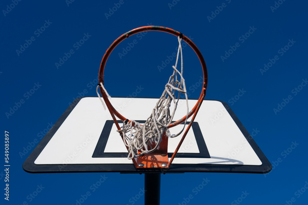 Basket ball hoop with backboard with blue sky