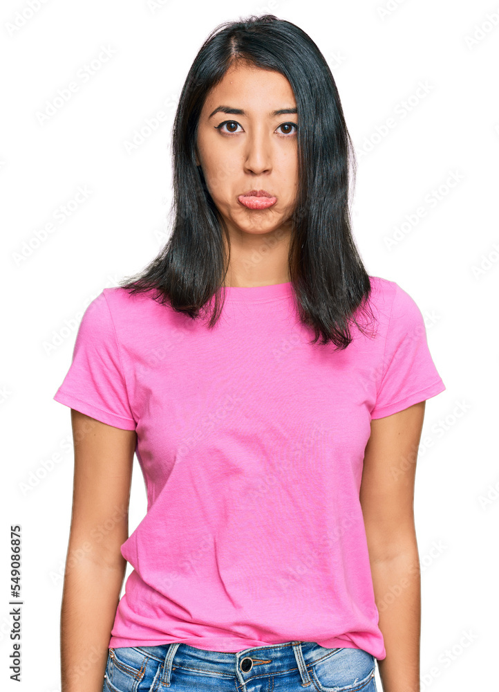 Beautiful asian young woman wearing casual pink t shirt depressed and worry for distress, crying angry and afraid. sad expression. Beautiful asian young woman wearing casual pink t shirt depressed and worry for distress, crying angry and afraid. sad expression.