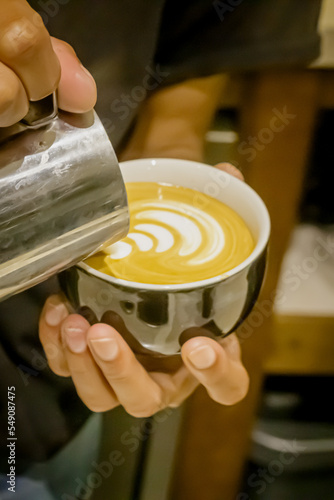 Hand on Barista making latte cafe, Cup of coffee with beautiful Latte art on white cup