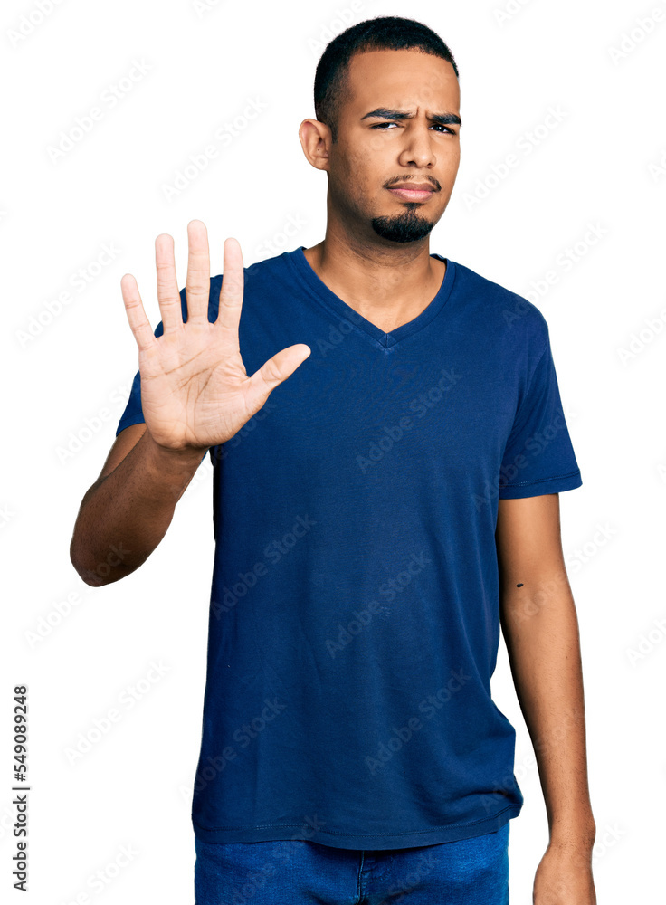 Young african american man wearing casual t shirt doing stop sing with palm of the hand. warning expression with negative and serious gesture on the face. Young african american man wearing casual t shirt doing stop sing with palm of the hand. warning expression with negative and serious gesture on the face.