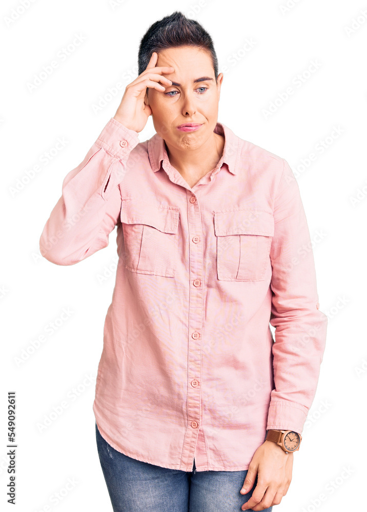Young woman with short hair wearing casual clothes worried and stressed about a problem with hand on forehead, nervous and anxious for crisis Young woman with short hair wearing casual clothes worried and stressed about a problem with hand on forehead, nervous and anxious for crisis