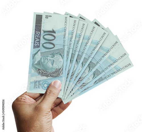 Male hand holding several 100 reais banknotes in a transparent background. Money from Brazil. 3d rendering.