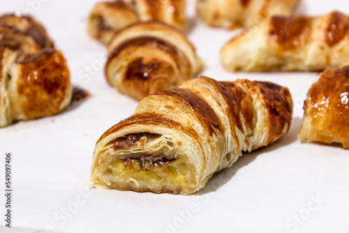 Baking in the form of a bagel with a filling inside of a whole banana and chocolate.