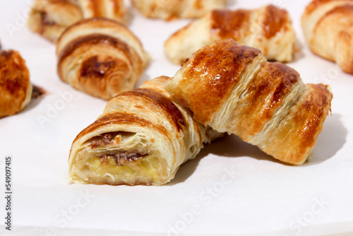 Baking in the form of a bagel with a filling inside of a whole banana and chocolate.