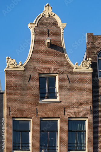 Close-up view details of old colorful building (XVI- XVIII centuries) with gable rooftop and hook along Korte Prinsengracht Canal in Amsterdam. Amsterdam, the Netherlands.