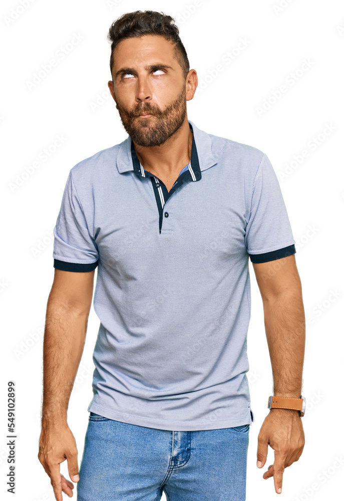 Handsome man with beard wearing casual clothes making fish face with lips, crazy and comical gesture. funny expression. Handsome man with beard wearing casual clothes making fish face with lips, crazy and comical gesture. funny expression.