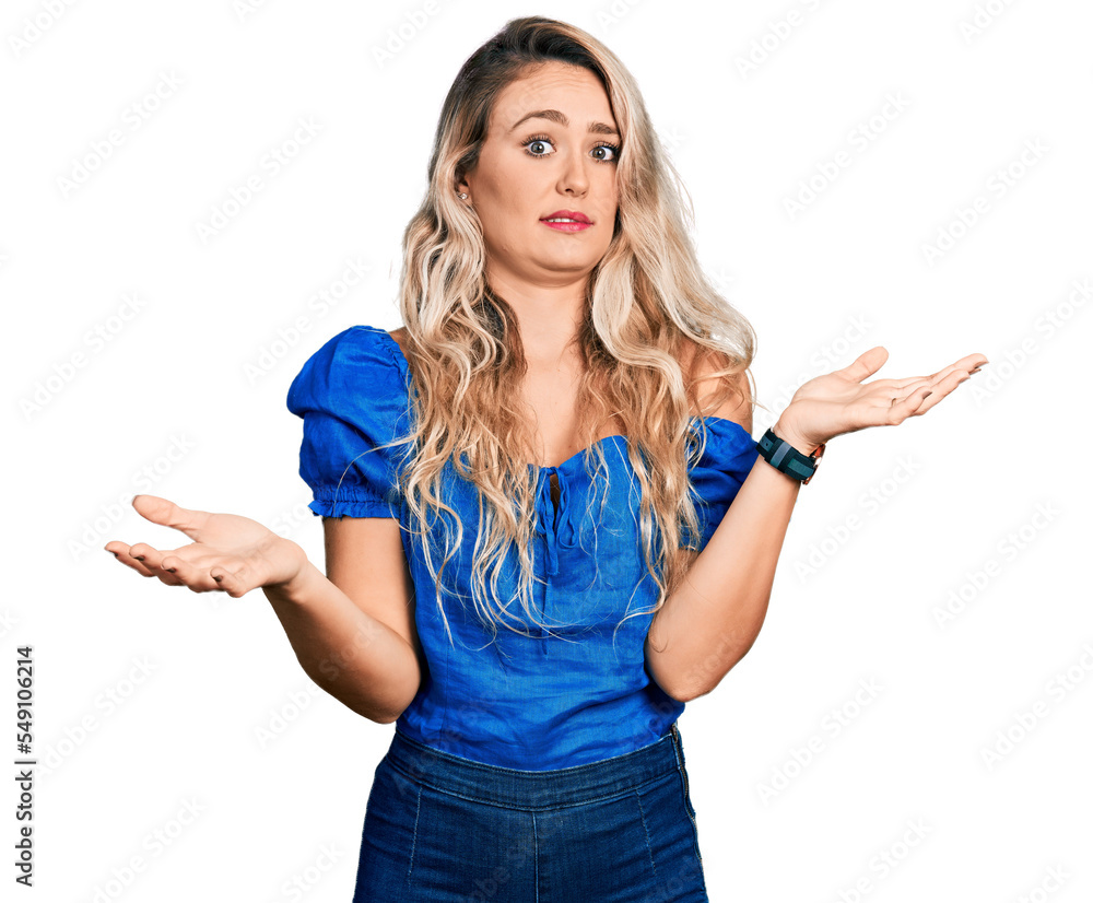 Young blonde woman wearing casual clothes clueless and confused with open arms, no idea concept. Young blonde woman wearing casual clothes clueless and confused with open arms, no idea concept.