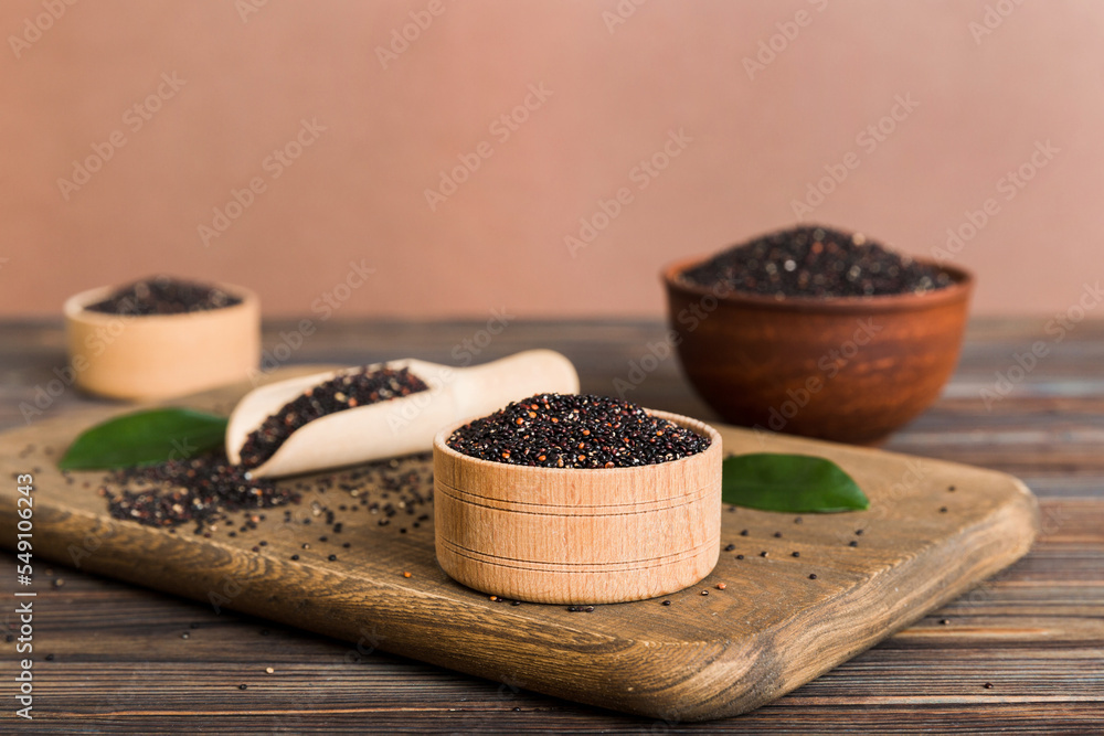 quinoa seeds in bowl and spoon on colored background. Healthy kinwa in small bowl. Healthy superfood quinoa seeds in bowl and spoon on colored background. Healthy kinwa in small bowl. Healthy superfood