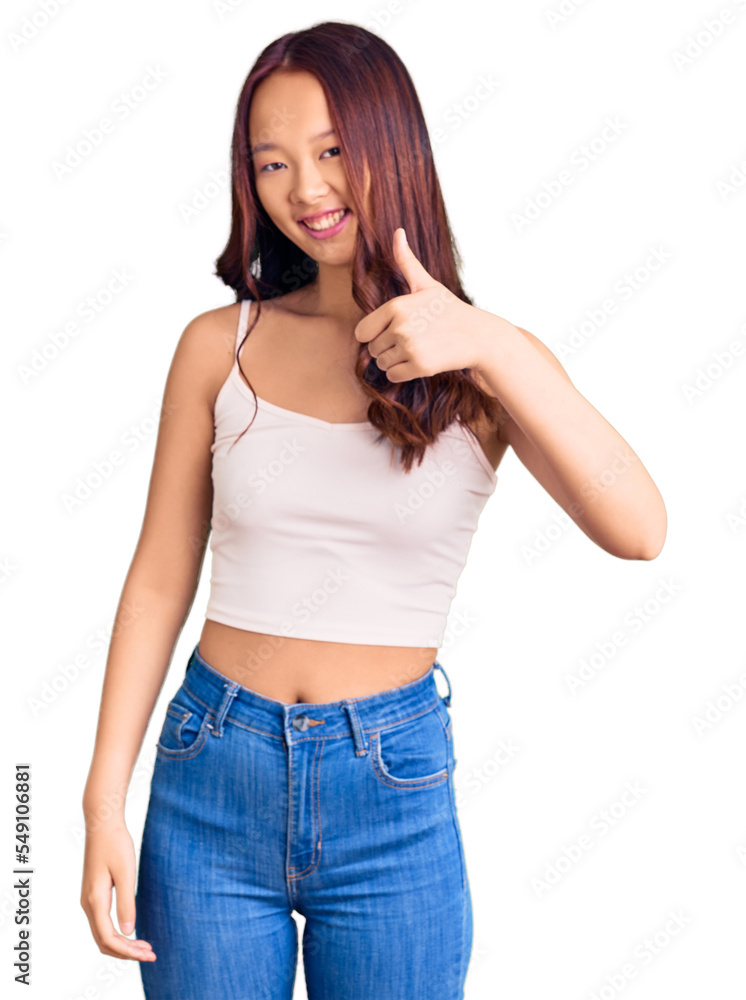 Young beautiful chinese girl wearing casual clothes doing happy thumbs up gesture with hand. approving expression looking at the camera showing success. Young beautiful chinese girl wearing casual clothes doing happy thumbs up gesture with hand. approving expression looking at the camera showing success.