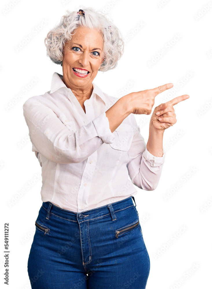 Senior grey-haired woman wearing casual clothes smiling and looking at the camera pointing with two hands and fingers to the side. Senior grey-haired woman wearing casual clothes smiling and looking at the camera pointing with two hands and fingers to the side.