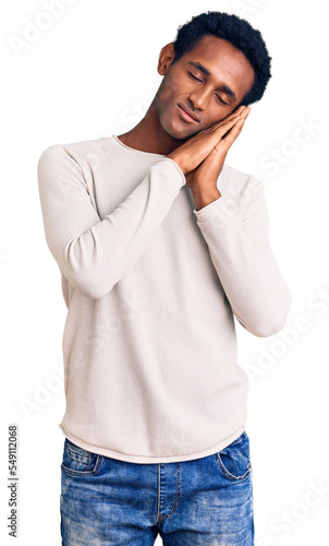 African handsome man wearing casual winter sweater sleeping tired dreaming and posing with hands together while smiling with closed eyes.