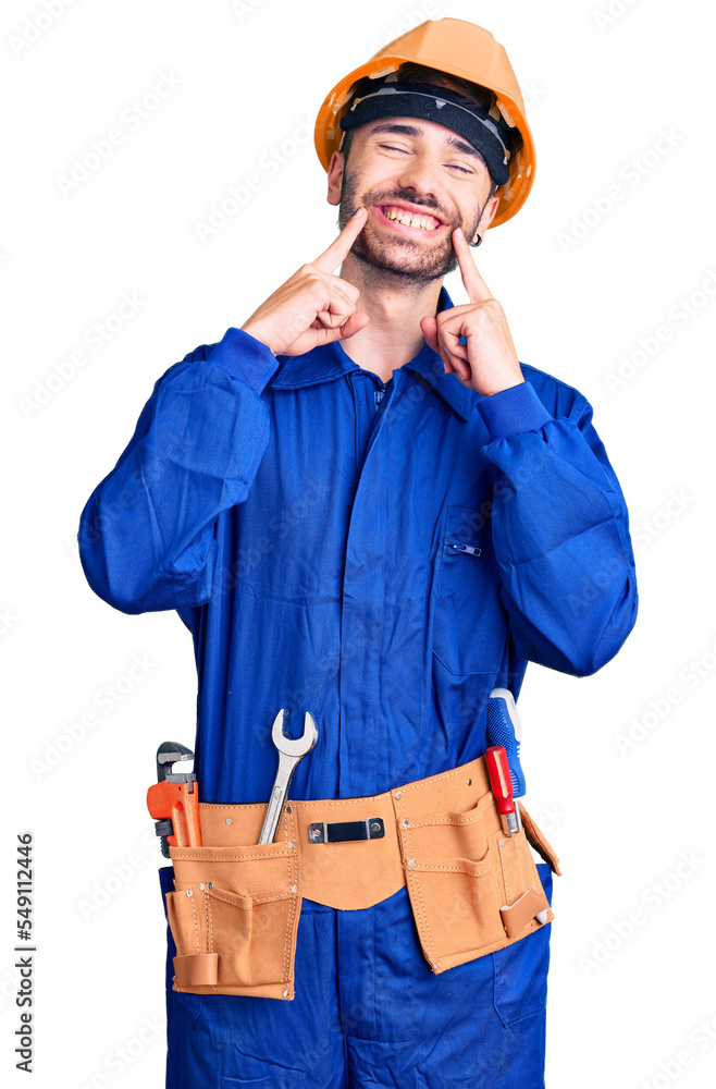 Young hispanic man wearing worker uniform smiling with open mouth, fingers pointing and forcing cheerful smile Young hispanic man wearing worker uniform smiling with open mouth, fingers pointing and forcing cheerful smile