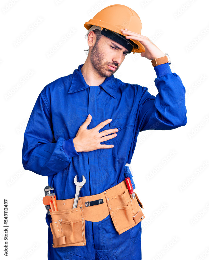 Young hispanic man wearing worker uniform touching forehead for illness and fever, flu and cold, virus sick Young hispanic man wearing worker uniform touching forehead for illness and fever, flu and cold, virus sick