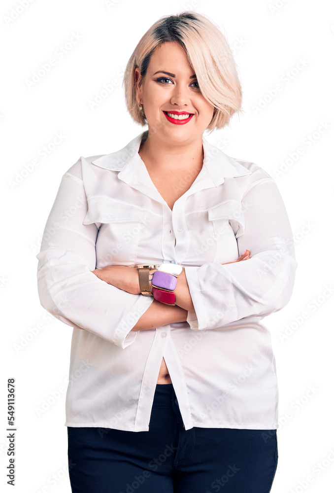 Young blonde plus size woman wearing casual shirt happy face smiling with crossed arms looking at the camera. positive person. Young blonde plus size woman wearing casual shirt happy face smiling with crossed arms looking at the camera. positive person.