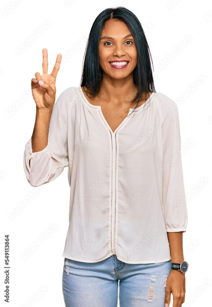 Young african american woman wearing casual clothes smiling with happy face winking at the camera doing victory sign. number two. Young african american woman wearing casual clothes smiling with happy face winking at the camera doing victory sign. number two.