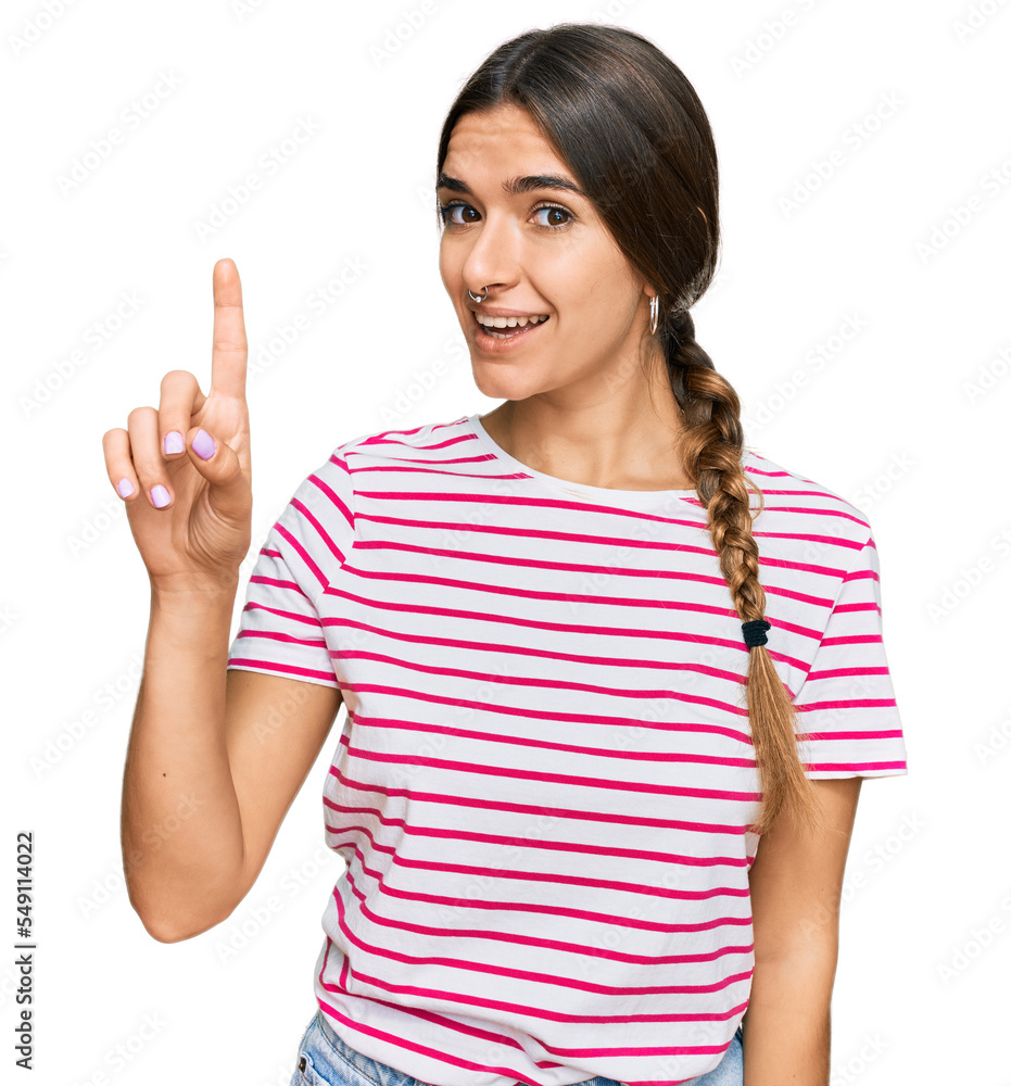 Young hispanic woman wearing casual clothes showing and pointing up with finger number one while smiling confident and happy. Young hispanic woman wearing casual clothes showing and pointing up with finger number one while smiling confident and happy.