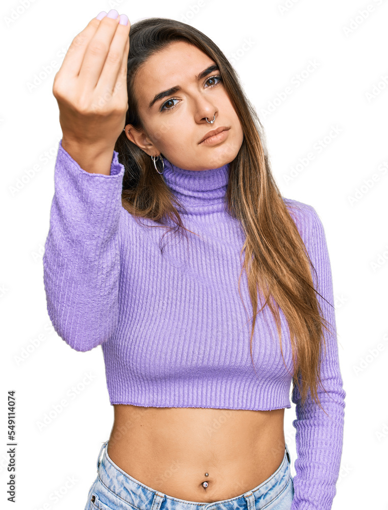 Young hispanic woman wearing casual clothes doing italian gesture with hand and fingers confident expression