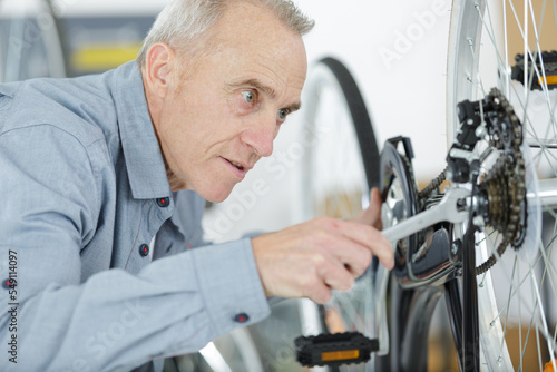 senior man fixing a bike problem