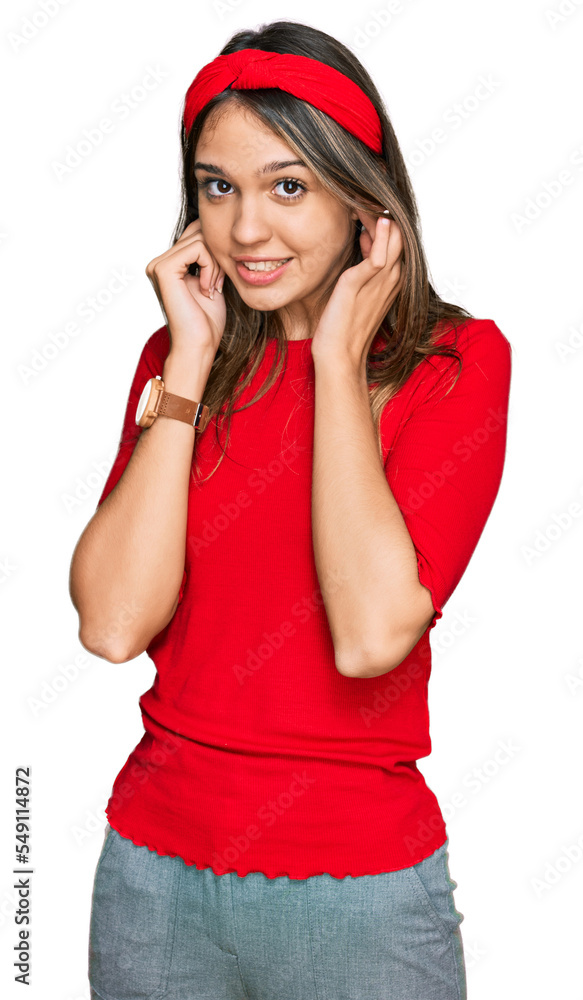 Young brunette woman wearing casual clothes covering ears with fingers with annoyed expression for the noise of loud music. deaf concept. Young brunette woman wearing casual clothes covering ears with fingers with annoyed expression for the noise of loud music. deaf concept.