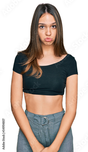 Young brunette woman wearing casual clothes depressed and worry for distress, crying angry and afraid. sad expression. © Krakenimages.com