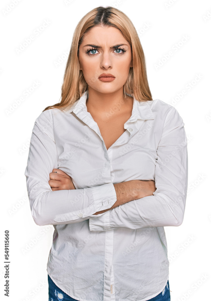Young caucasian woman wearing casual clothes skeptic and nervous, disapproving expression on face with crossed arms. negative person. Young caucasian woman wearing casual clothes skeptic and nervous, disapproving expression on face with crossed arms. negative person.