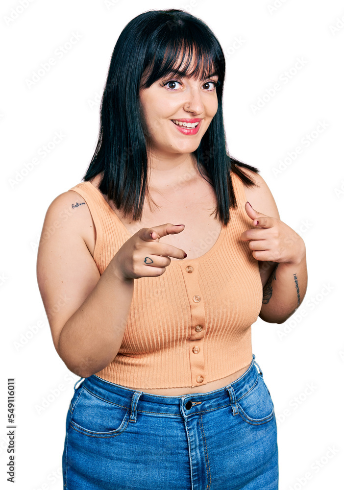 Young hispanic plus size woman wearing casual clothes pointing fingers to camera with happy and funny face. good energy and vibes. Young hispanic plus size woman wearing casual clothes pointing fingers to camera with happy and funny face. good energy and vibes.