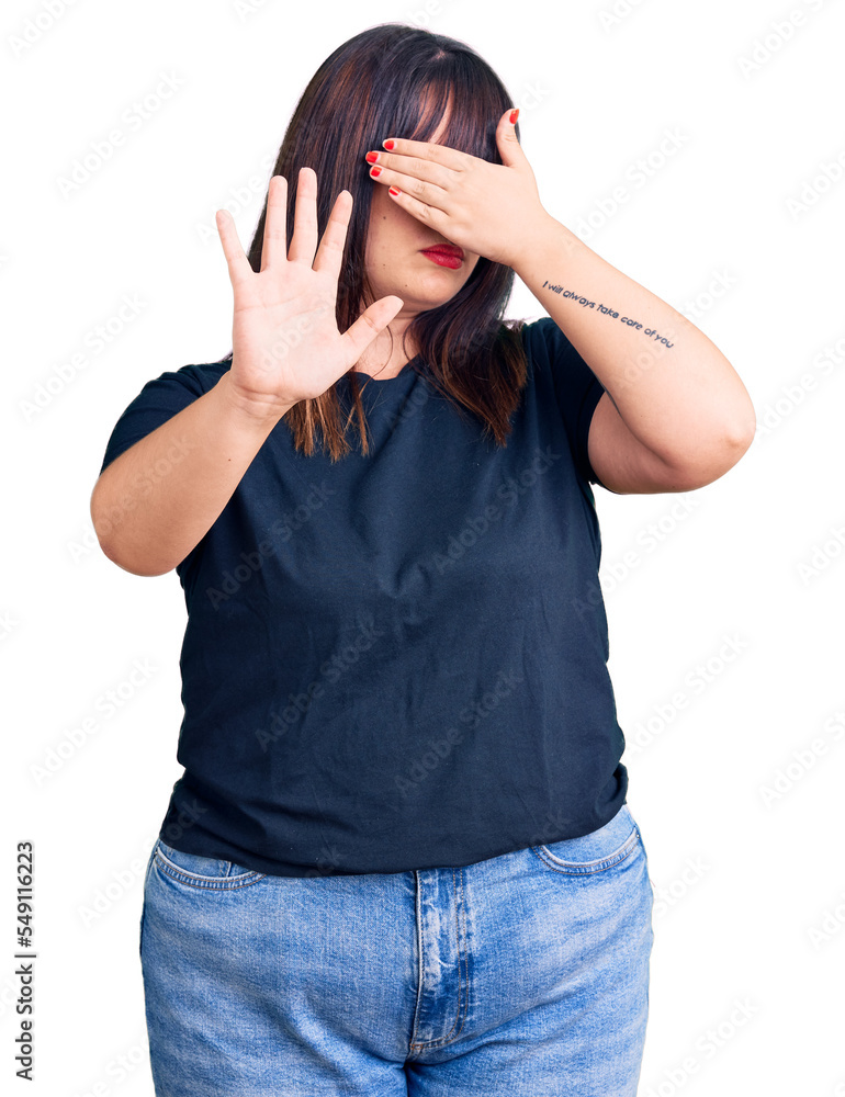 Young plus size woman wearing casual clothes covering eyes with hands and doing stop gesture with sad and fear expression. embarrassed and negative concept. Young plus size woman wearing casual clothes covering eyes with hands and doing stop gesture with sad and fear expression. embarrassed and negative concept.