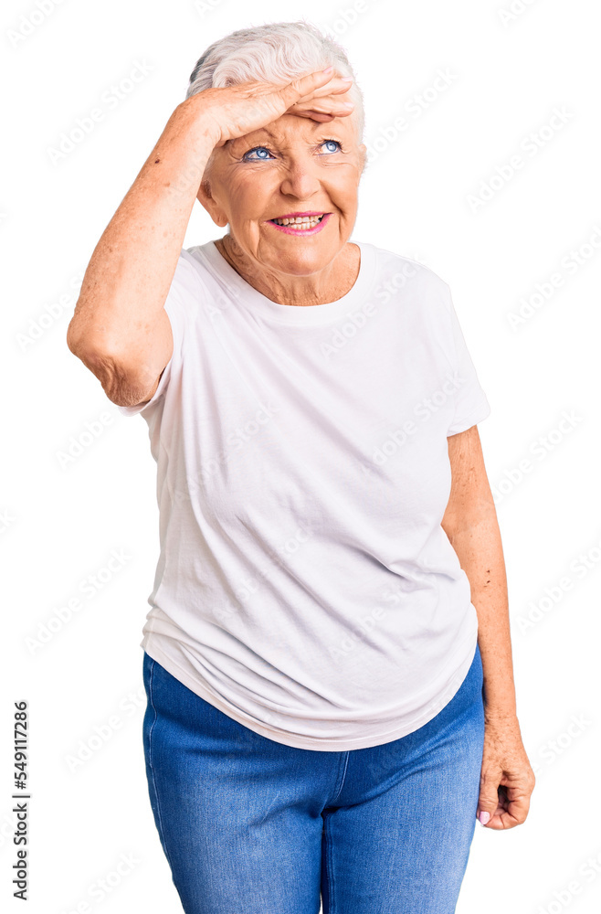Senior beautiful woman with blue eyes and grey hair wearing casual white tshirt very happy and smiling looking far away with hand over head. searching concept. Senior beautiful woman with blue eyes and grey hair wearing casual white tshirt very happy and smiling looking far away with hand over head. searching concept.