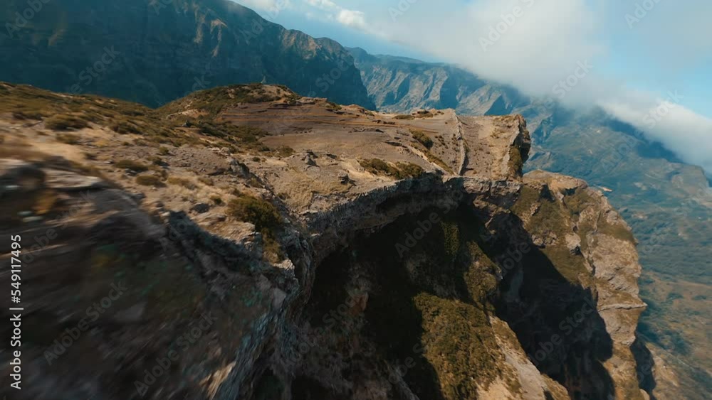 Drone flying over a cliff in the mountains on the island of Madeira in Portugal Drone flying over a cliff in the mountains on the island of Madeira in Portugal