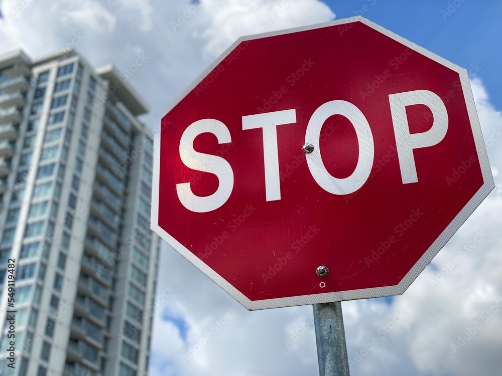 stop sign on blue sky background city 
