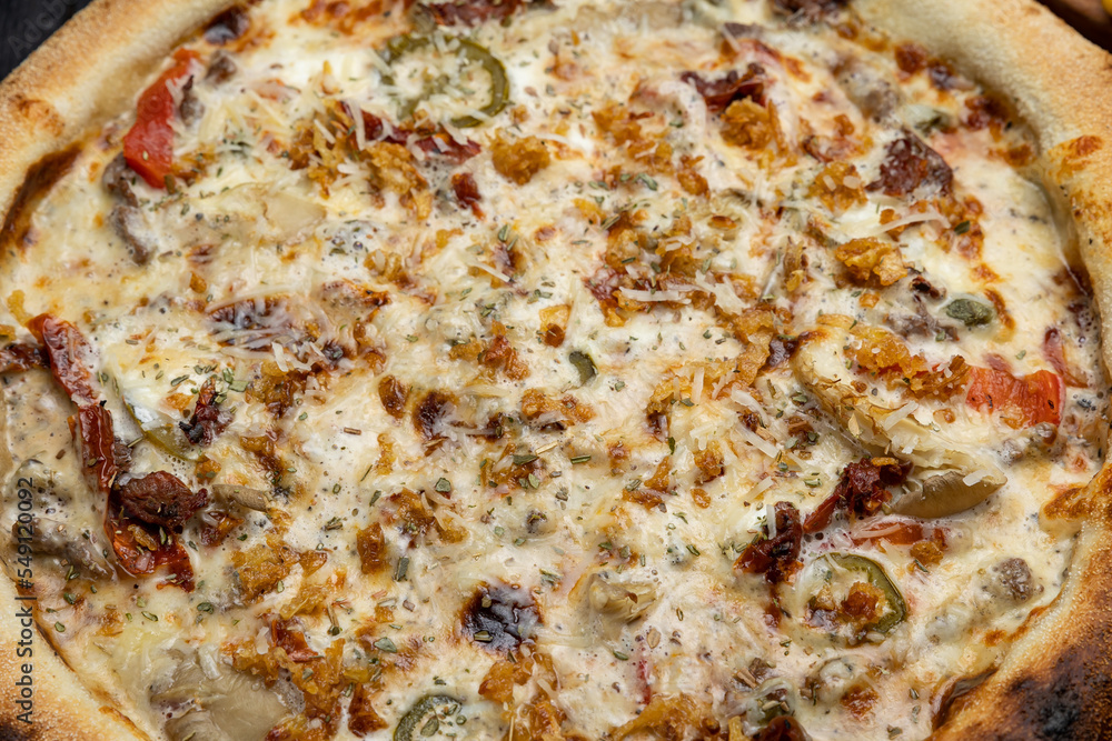 tasty pizza with cheese and vegetables on a wooden dark table
tasty pizza with cheese and vegetables on a wooden dark table
