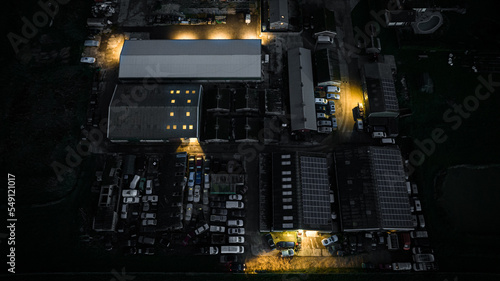 Aerial view of small industial estate at night with few units still open, West Sussex, UK