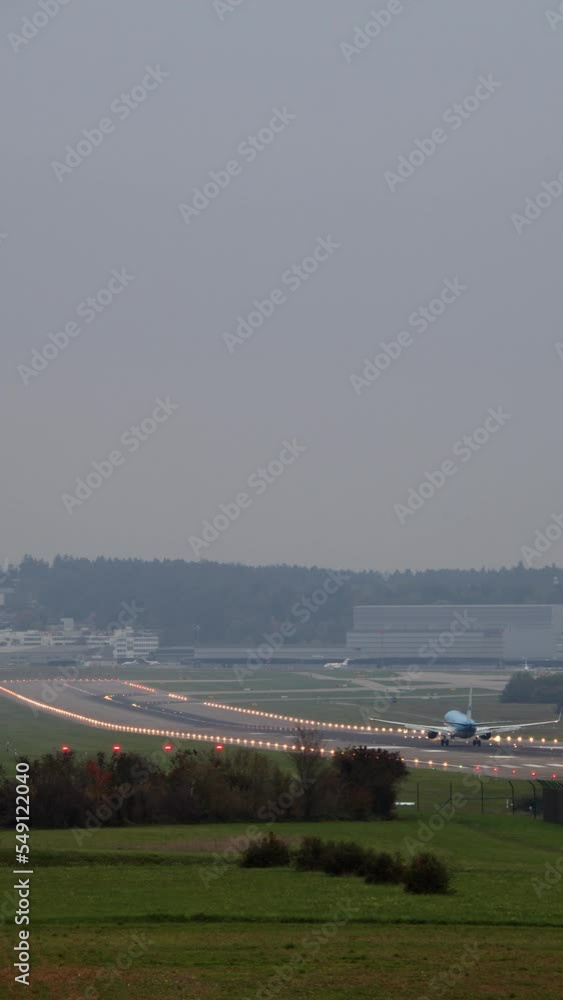 Vertical video - airplane landing at the airport Vertical video - airplane landing at the airport