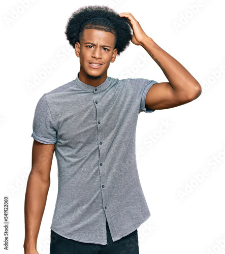 African american man with afro hair wearing casual clothes confuse and wonder about question. uncertain with doubt, thinking with hand on head. pensive concept.