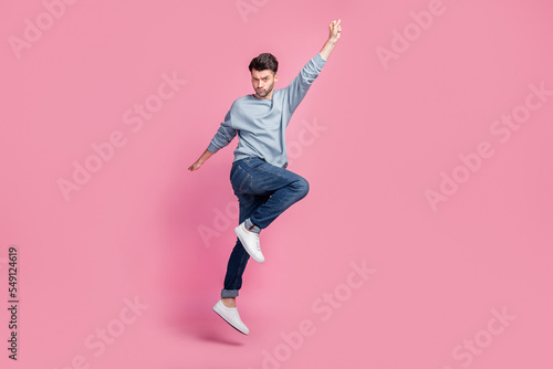 Full body size photo of young handsome attractive serious grimace man hand up look you confident superhero fly home isolated on pink color background