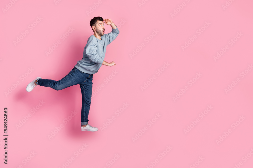 Full body photo of nice young guy carry cart look empty space hand forehead dressed trendy blue clothes isolated on pink color background