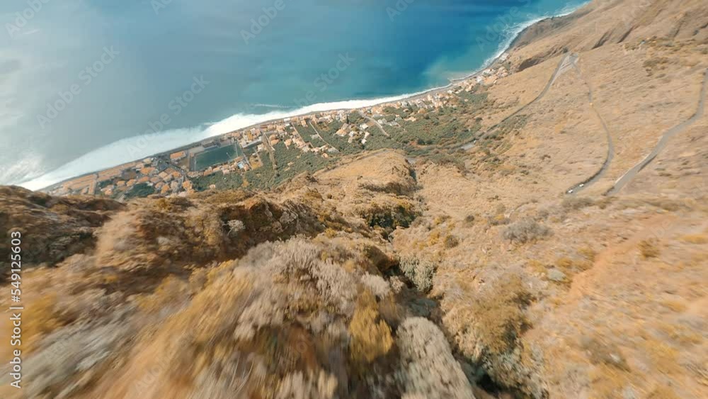 Drone flying over a cliff in the mountains on the island of Madeira in Portugal Drone flying over a cliff in the mountains on the island of Madeira in Portugal