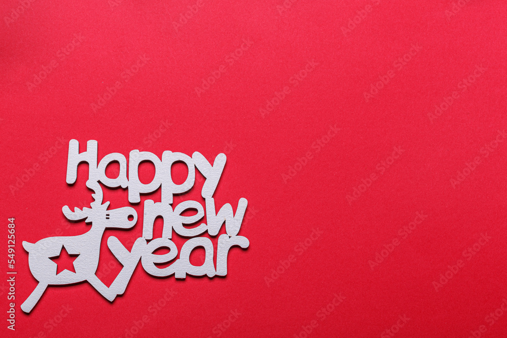 beautiful branches of a Christmas tree with cones and toys on a red background with the inscription Happy New Year beautiful branches of a Christmas tree with cones and toys on a red background with the inscription Happy New Year
