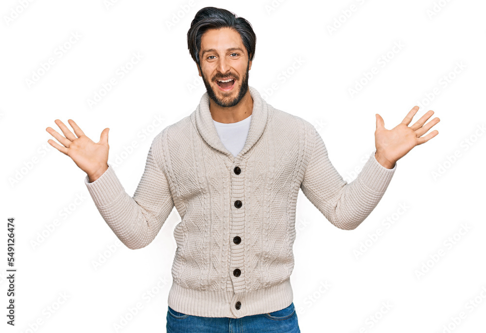 Young hispanic man wearing casual clothes celebrating victory with happy smile and winner expression with raised hands