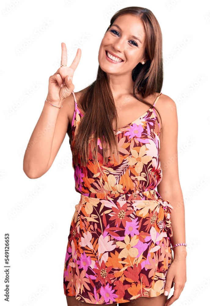 Young beautiful hispanic woman wearing casual clothes showing and pointing up with fingers number two while smiling confident and happy. Young beautiful hispanic woman wearing casual clothes showing and pointing up with fingers number two while smiling confident and happy.