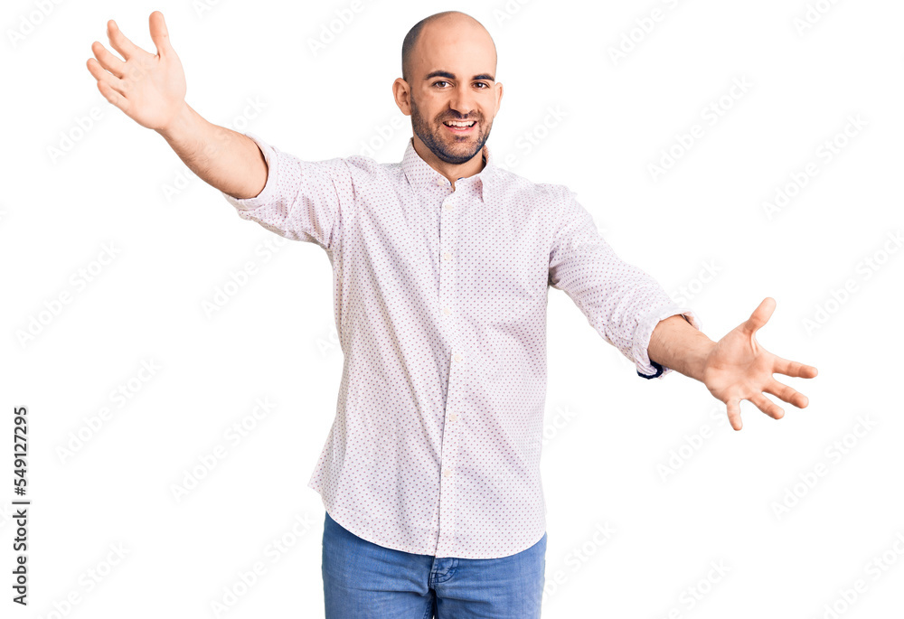 Young handsome man wearing elegant shirt looking at the camera smiling with open arms for hug. cheerful expression embracing happiness. Young handsome man wearing elegant shirt looking at the camera smiling with open arms for hug. cheerful expression embracing happiness.
