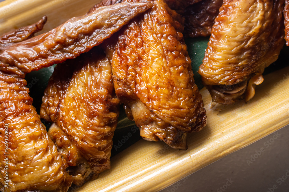Takeout Japanese-style Tebasaki (chicken wing tip) packed in food plastic container. Sold by Japanese supermarket. Takeout Japanese-style Tebasaki (chicken wing tip) packed in food plastic container. Sold by Japanese supermarket.