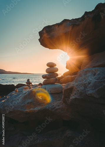 stones in the sea during sunset