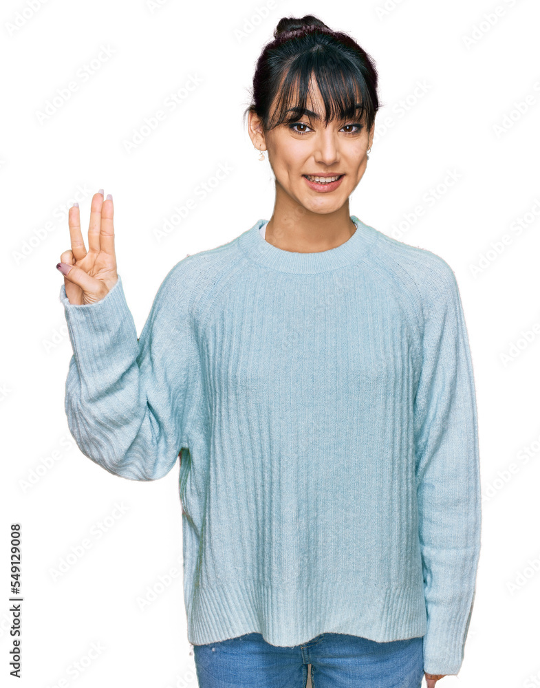 Young hispanic woman wearing casual clothes showing and pointing up with fingers number three while smiling confident and happy. Young hispanic woman wearing casual clothes showing and pointing up with fingers number three while smiling confident and happy.