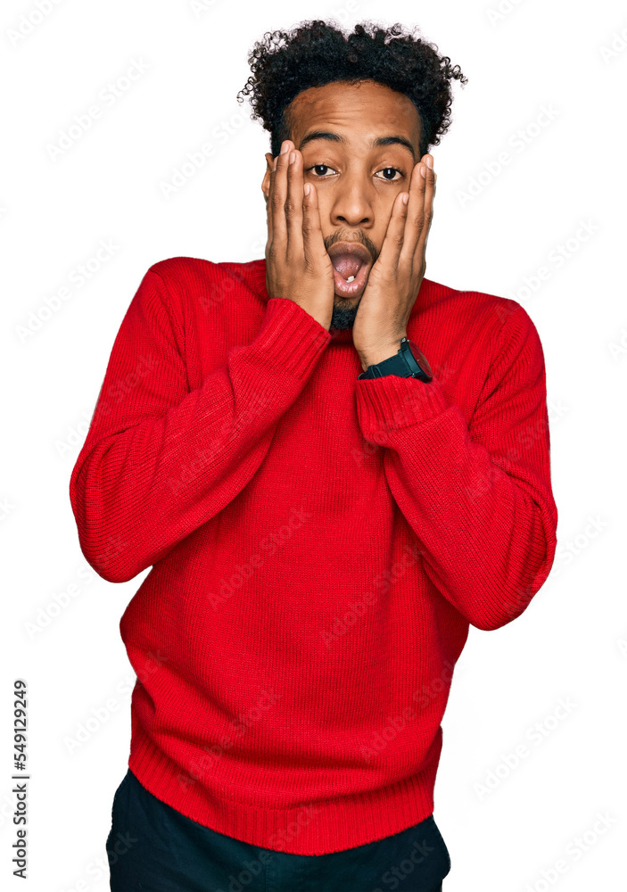 Young african american man with beard wearing casual winter sweater afraid and shocked, surprise and amazed expression with hands on face Young african american man with beard wearing casual winter sweater afraid and shocked, surprise and amazed expression with hands on face