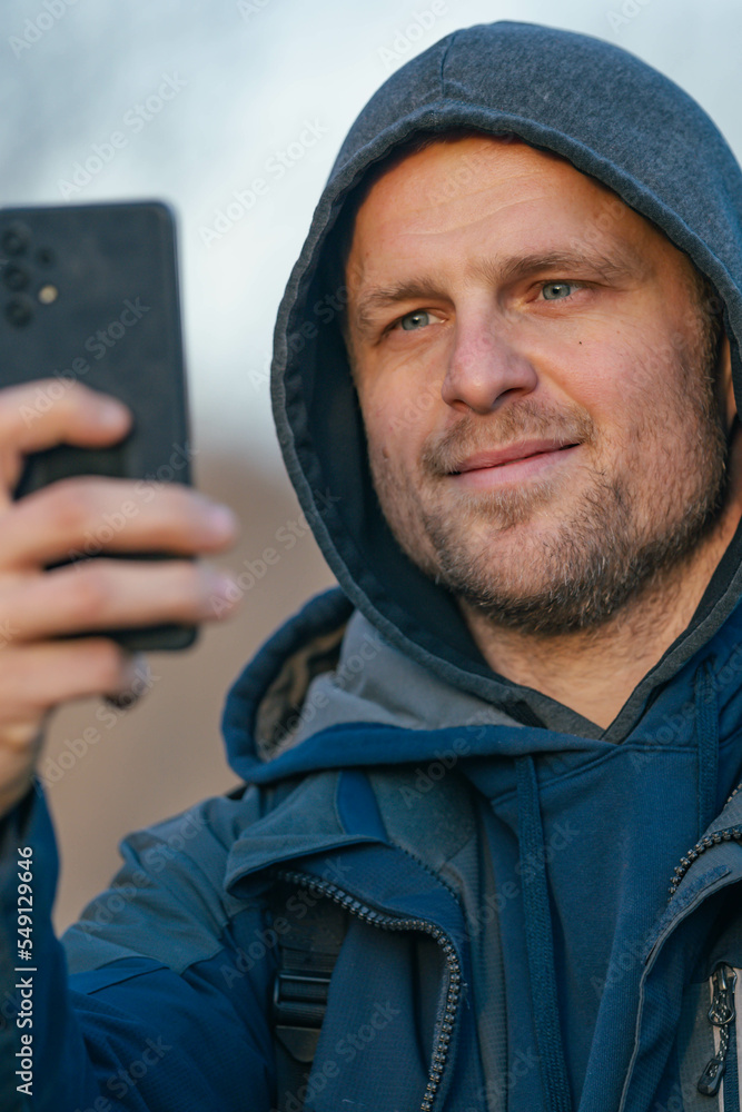 person in outdoors environment cold weather taking a selfie in natural environment person in outdoors environment cold weather taking a selfie in natural environment