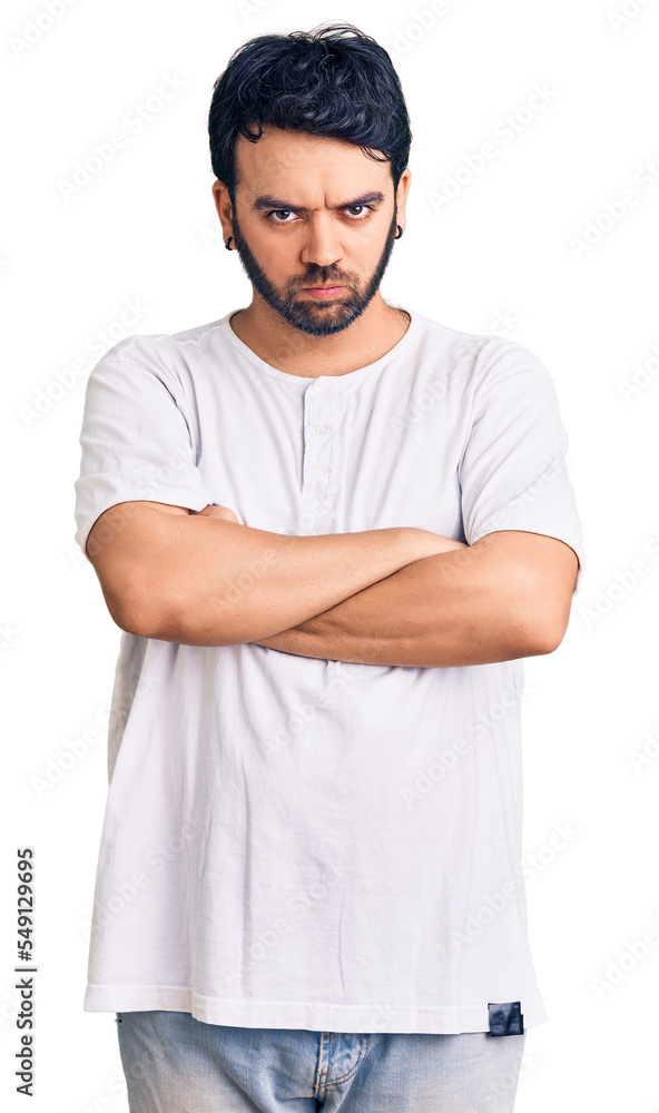 Young hispanic man wearing casual clothes skeptic and nervous, disapproving expression on face with crossed arms. negative person. Young hispanic man wearing casual clothes skeptic and nervous, disapproving expression on face with crossed arms. negative person.
