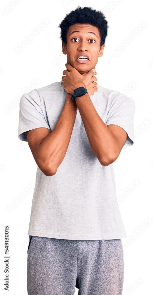 Young african american man wearing casual clothes shouting and suffocate because painful strangle. health problem. asphyxiate and suicide concept. Young african american man wearing casual clothes shouting and suffocate because painful strangle. health problem. asphyxiate and suicide concept.