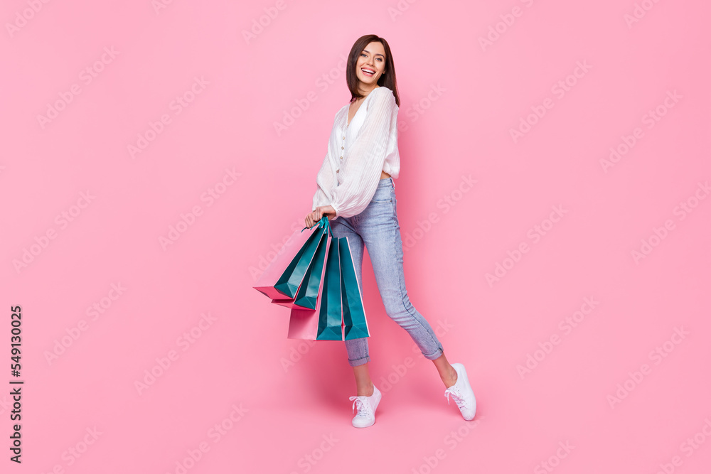 Full length photo of pretty adorable lady skinny figure dressed trendy clothes enjoy new collection isolated pink color background Full length photo of pretty adorable lady skinny figure dressed trendy clothes enjoy new collection isolated pink color background